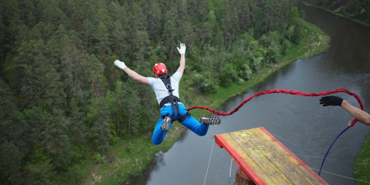 An extreme sportsman jumps on a rope from a great height. Ropejumping.